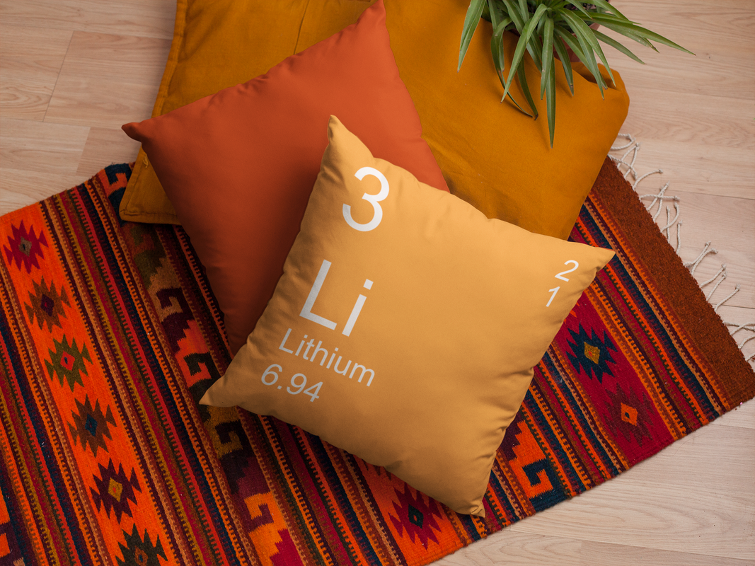Orange Lithium Element Pillow on Rug