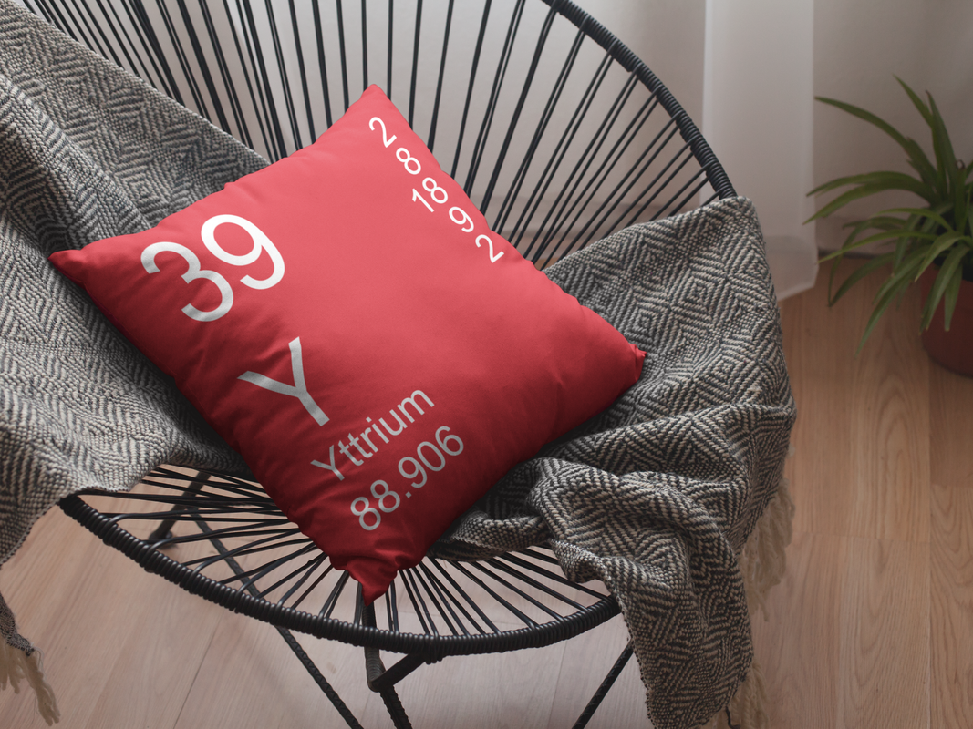 Red Yttrium Element Pillow on Cool Chair