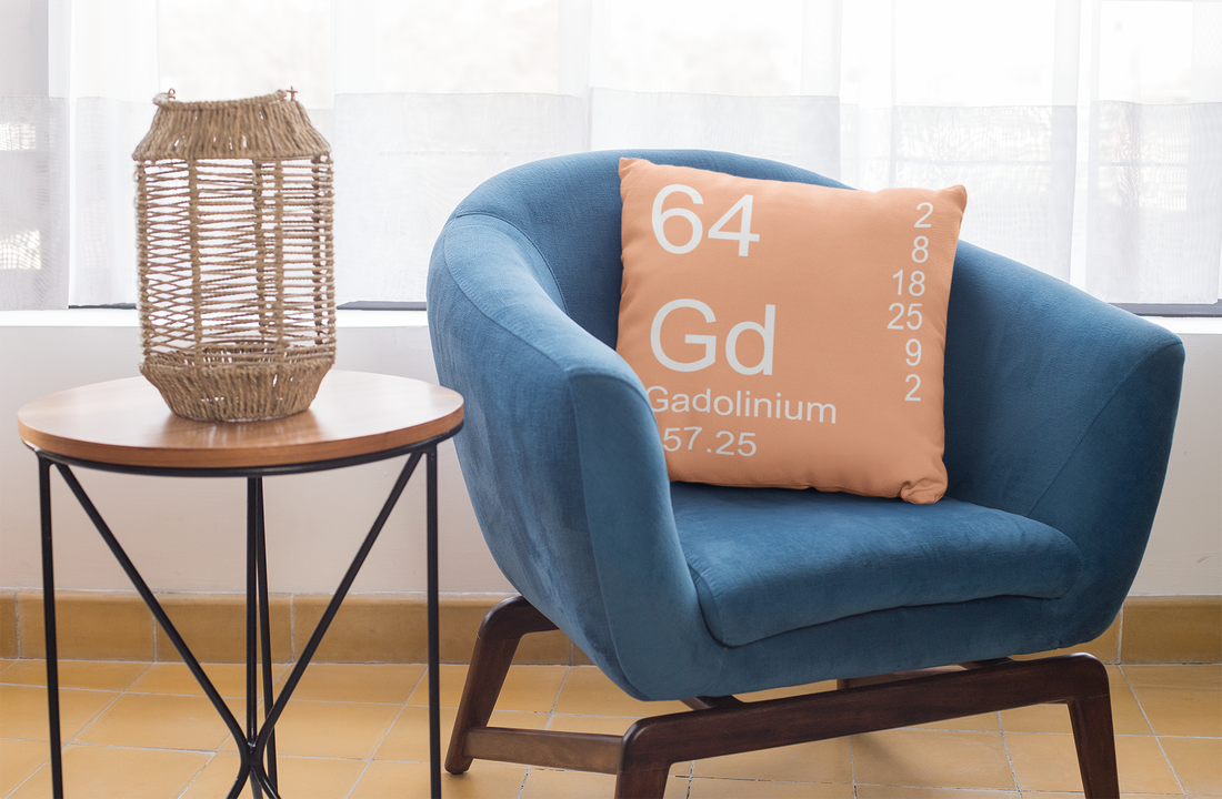 Peach Gadolinium Element Pillow on Blue Chair