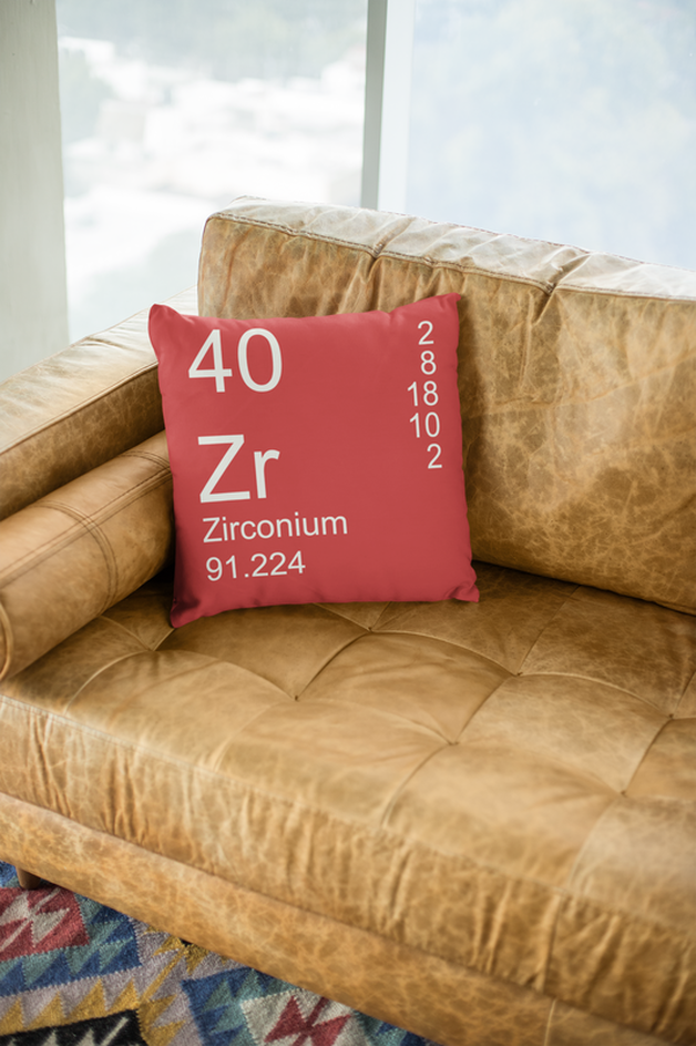 Red Zirconium Element Pillow on Leather Couch