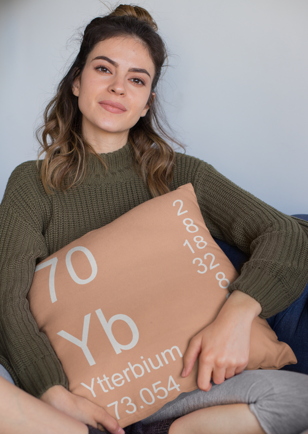 Peach Ytterbium Element Pillow Held by Woman